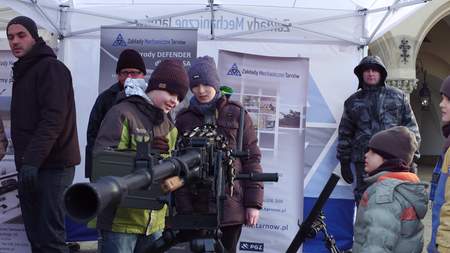 KRAKOW, POLAND - JANUARY, 14, 2017 Little boys examine heavy machine gun at WOSP show
