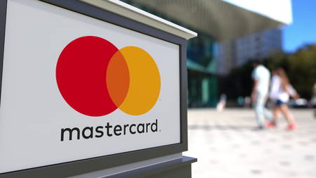 Street signage board with MasterCard logo. Blurred office center and walking people background. Editorial 3D renderingのeditorial素材