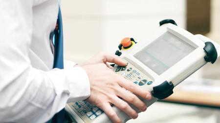 Robotics engineer using industrial touchscreen computerの写真素材