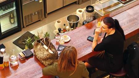 WARSAW, POLAND - MARCH, 4, 2017. Two female friends sitting at the bar and chattingのeditorial素材