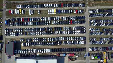 Aerial shot of new cars and trucks parking