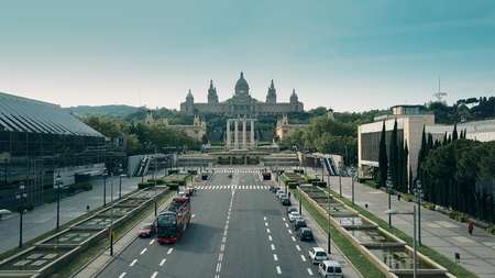 BARCELONA, SPAIN - APRIL, 15, 2017. Aerial shot of tour bus and Palau Nacional - National Palace on a sunny dayのeditorial素材