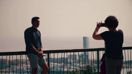 BARCELONA, SPAIN - APRIL, 16, 2017. Tourists posing and making photos at city viewing pointのeditorial素材