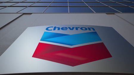 Outdoor signage board with Chevron Corporation logo. Modern office building. Editorial 3D