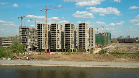 Aerial shot of a modern apartment buildings construction site near waterfrontの写真素材