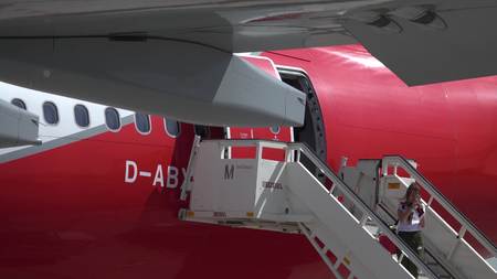 BERLIN, GERMANY - MAY, 18, 2017. Young woman making selfie while boarding Air Berlin plane at the airportのeditorial素材