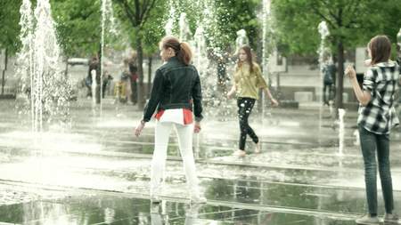 MOSCOW, RUSSIA - MAY, 24, 2017. Girls having having fun in the park fountain. Hot summer in the cityのeditorial素材