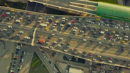 Aerial top down view shot of traffic jam on both sides of a highway in the evening rush hourの写真素材