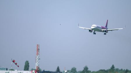 WARSAW, POLAND - MAY, 18, 2017. Wizz Air airliner landing at the airport beyond heat hazeのeditorial素材