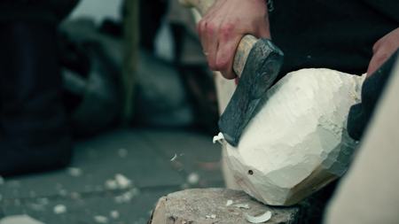 Craftsman hewing wooden bailer with a hatchetの写真素材