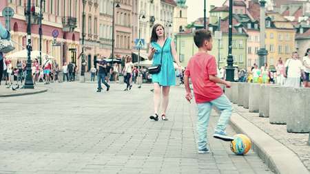WARSAW, POLAND - JUNE 10, 2017. Boy playing with a ball on the streetのeditorial素材