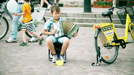 WARSAW, POLAND - JUNE 10, 2017. Little boy playing the accordion on the streetのeditorial素材