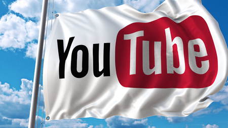 Waving flag with Youtube logo against sky and clouds. Editorial 3D rendering