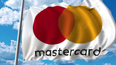 Waving flag with Mastercard logo against sky and clouds. Editorial 3D renderingのeditorial素材
