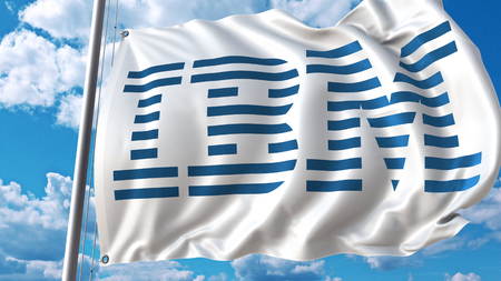 Waving flag with IBM logo against sky and clouds. Editorial 3D renderingのeditorial素材