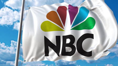 Foto de Waving flag with NBC logo against sky and clouds. Editorial 3D rendering - Imagen libre de derechos