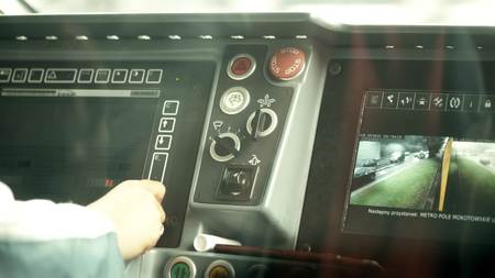 WARSAW, POLAND - JUNE 26, 2017. Modern tram control panel and the drivers hand. Public transport...