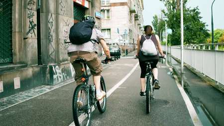 WARSAW, POLAND - JULY 11, 2017. Young people cycling along the city bike road