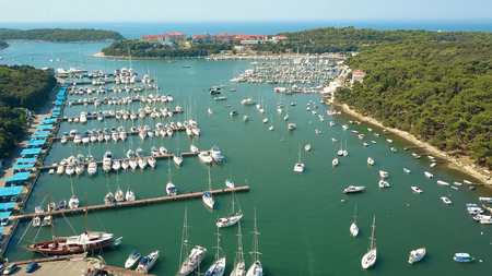 Aerial shot of multiple parked boats, motorboats and sailboats at the Adriatic sea marinaの写真素材