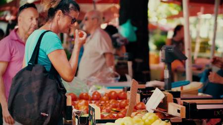 PULA, CROATIA - AUGUST 4, 2017. Woman buying tomatoes at local farmers marketplaceのeditorial素材