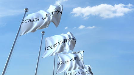 Waving flags with Louis Vuitton logo against sky, editorial 3D renderingのeditorial素材