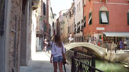 VENICE, ITALY - AUGUST 8, 2017. Famous Venetian canal and pedestrian bridgeのeditorial素材