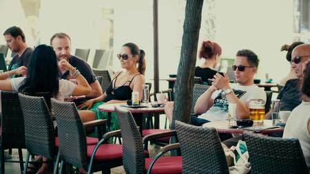 PULA, CROATIA - AUGUST 4, 2017. People socialize and eat out in a street cafeのeditorial素材