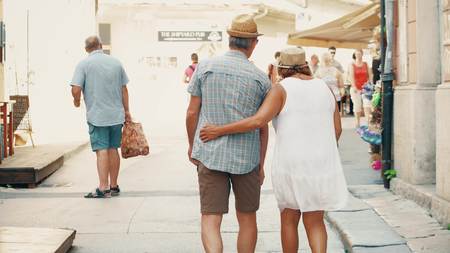PULA, CROATIA - AUGUST 4, 2017. Senior couple walking on the streetのeditorial素材