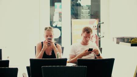PULA, CROATIA - AUGUST 4, 2017. Young couple using smartphones in a cafe. Modern social network addictionのeditorial素材