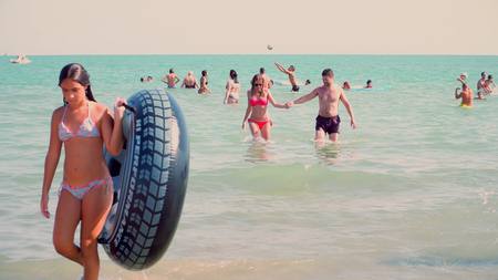 LIDO DI JESOLO, ITALY - AUGUST 8, 2017. People bathing and playing in the sea. Summer vacation timeのeditorial素材