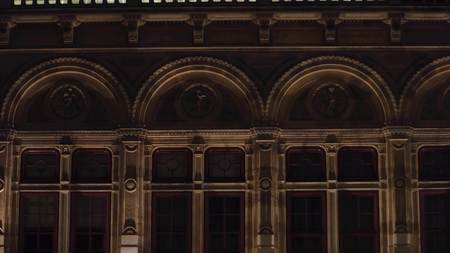 Old classic building windows illuminated at night in Vienna, Austriaの写真素材
