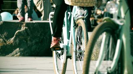 Unknown people riding classic bicycles on the streetの写真素材