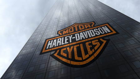Harley-Davidson logo on a skyscraper facade reflecting clouds. Editorial 3D rendering