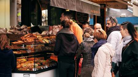 PARIS, FRANCE - OCTOBER 7, 2017. Customers at pastry stall on the streetのeditorial素材