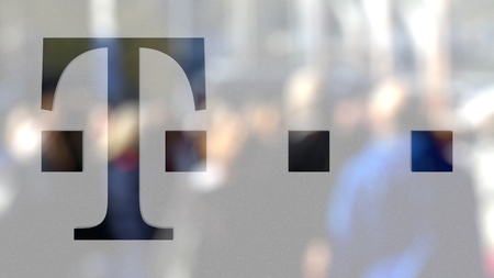 T-Mobile logo on a glass against blurred crowd on the steet. Editorial 3D renderingのeditorial素材