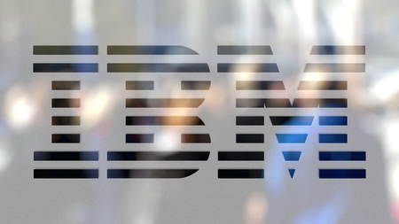 IBM logo on a glass against blurred crowd on the steet. Editorial 3D rendering