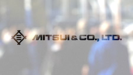 Mitsui and Co. logo on a glass against blurred crowd on the steet. Editorial 3D renderingのeditorial素材