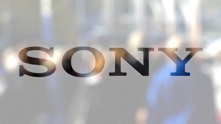 Sony Corporation logo on a glass against blurred crowd on the steet. Editorial 3D renderingのeditorial素材