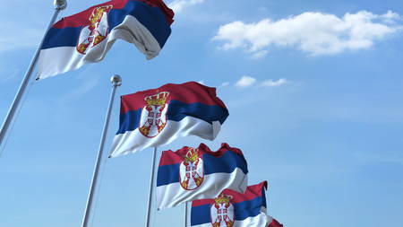 Multiple waving flags of Serbia against the blue sky. 3D renderingの写真素材