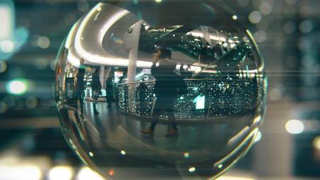 Customers walk in Christmas decorated shopping mall. View through the glass ball