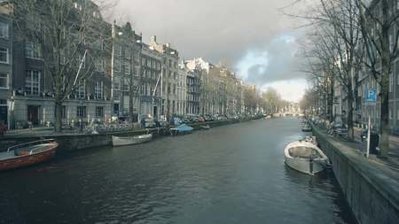 AMSTERDAM, THE NETHERLANDS - DECEMBER 25, 2017. Typical canal and houses alongside embankmentのeditorial素材