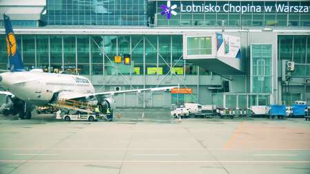WARSAW, POLAND - DECEMBER 25, 2017. Loading luggage to Lufthansa commercial airplane at the Chopin international airportのeditorial素材