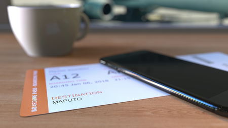 Boarding pass to Maputo and smartphone on the table in airport while travelling to Mozambique. 3D renderingの写真素材