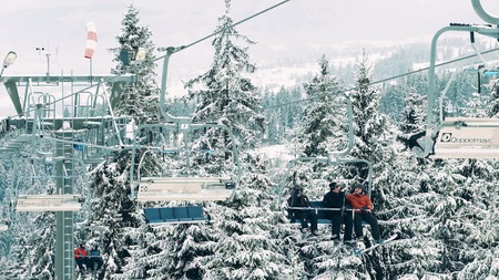 BIALKA TATRZANSKA, POLAND - FEBRUARY 3, 2018. Mountain ski lift or chairlift against the Tatra mountainsのeditorial素材