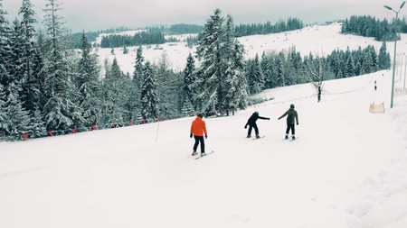 Unrecognizable mountain skiers on alpine ski slopeの写真素材