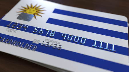 Plastic bank card featuring flag of Uruguay. National banking system related 3D renderingの写真素材
