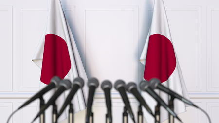 Japanese official press conference. Flags of Japan and microphones. Conceptual 3D renderingの写真素材