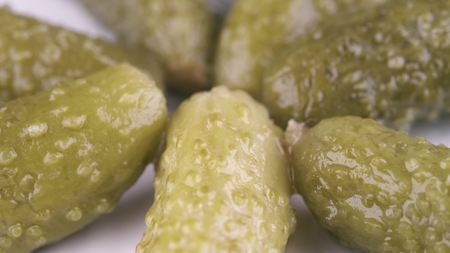 Pile of canned pickles on the plate, macro shotの写真素材