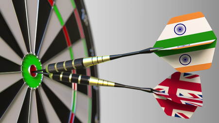 Flags of India and the United Kingdom on darts hitting bullseye of the target. International cooperation or competition conceptual 3D renderingの写真素材