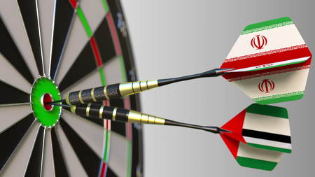 Flags of Iran and the UAE on darts hitting bullseye of the target. International cooperation or competition conceptual 3D renderingの写真素材